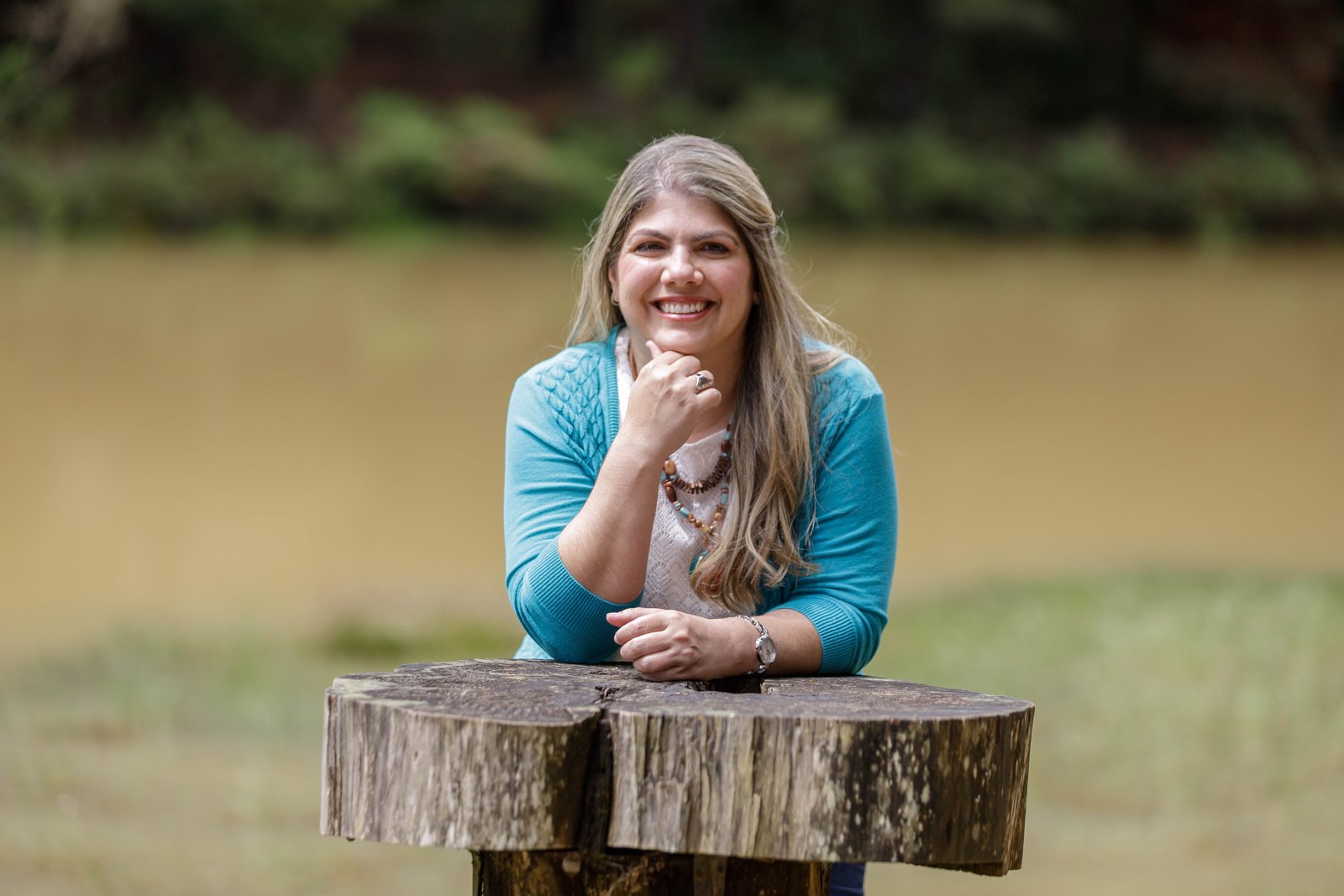 Mar Rodríguez sonriendo junto a una mesa de madera en la naturaleza